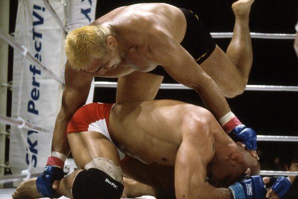 Kazuyuki Fujita prepares to knee a downed Mark Kerr.